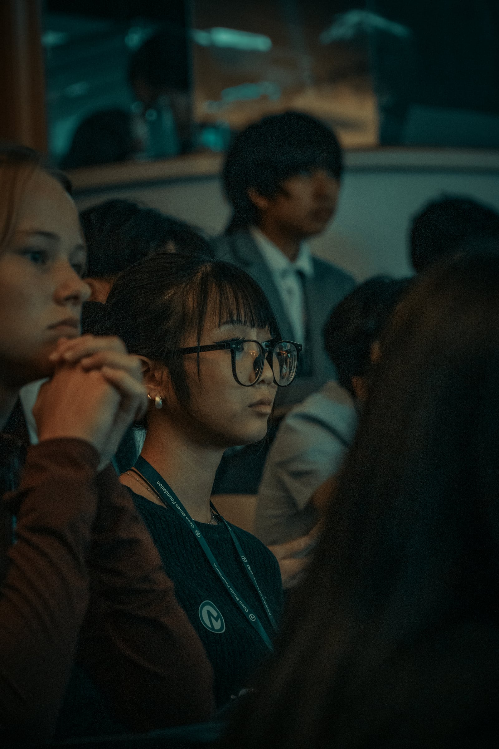 A student watching the presentations from the audience