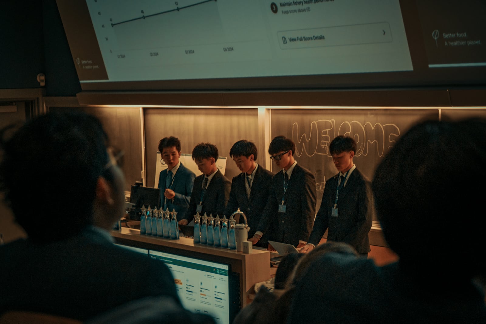 A team standing together at the podium during the presentations