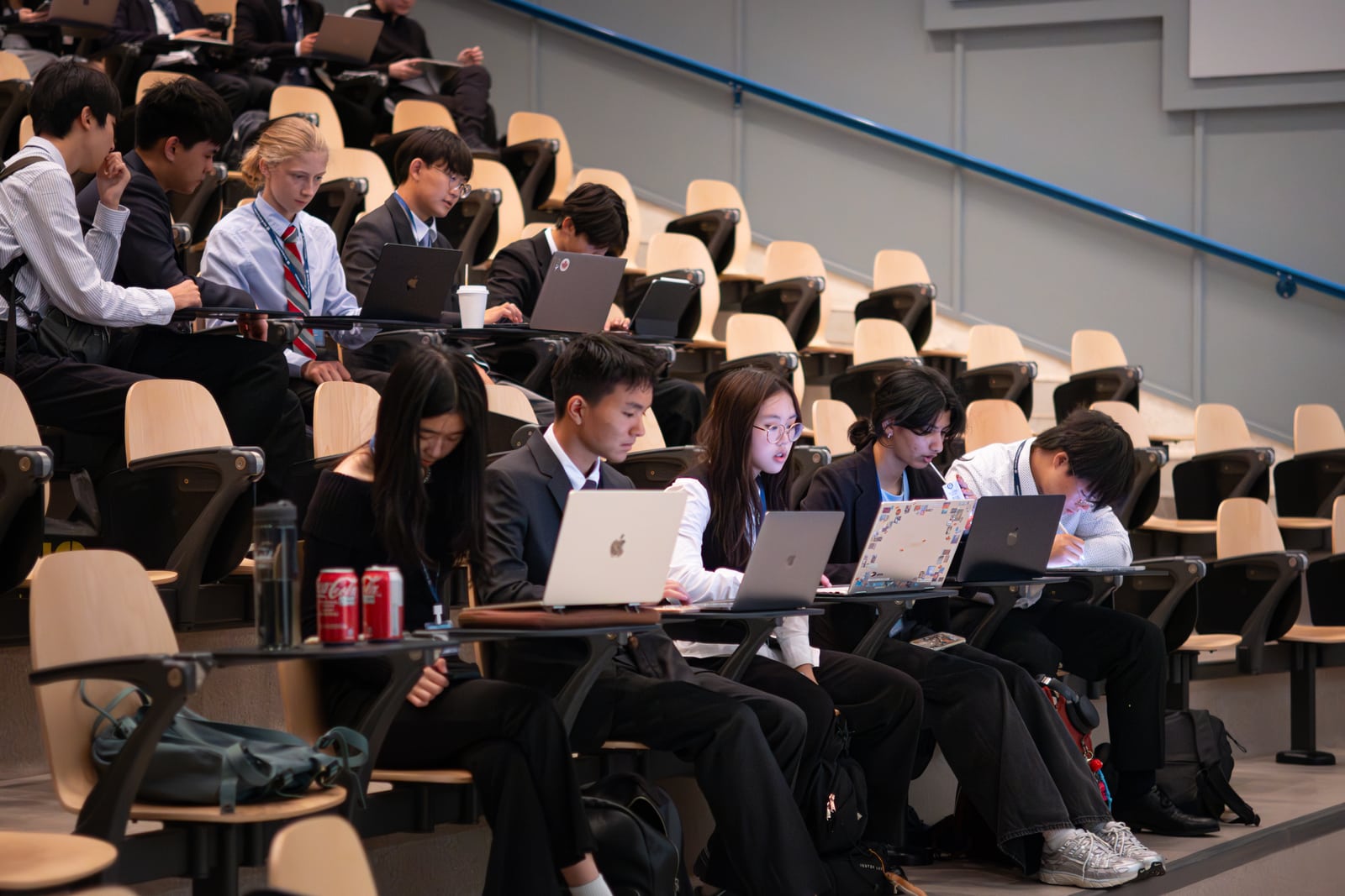 Teams working on laptops in the lecture hall