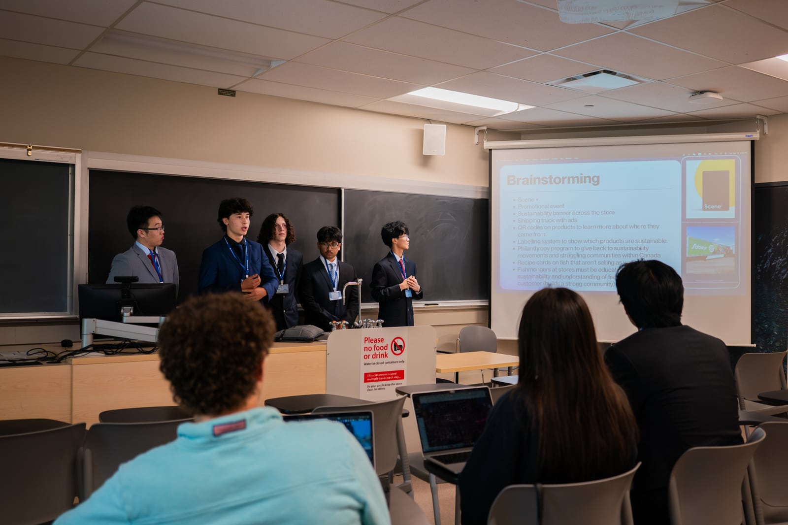 A team giving its preliminary-round presentation to the room