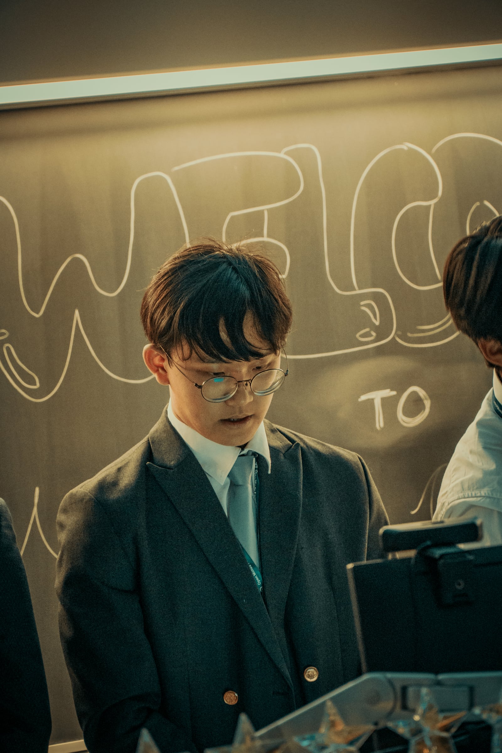 A student checking notes at the chalkboard before presenting