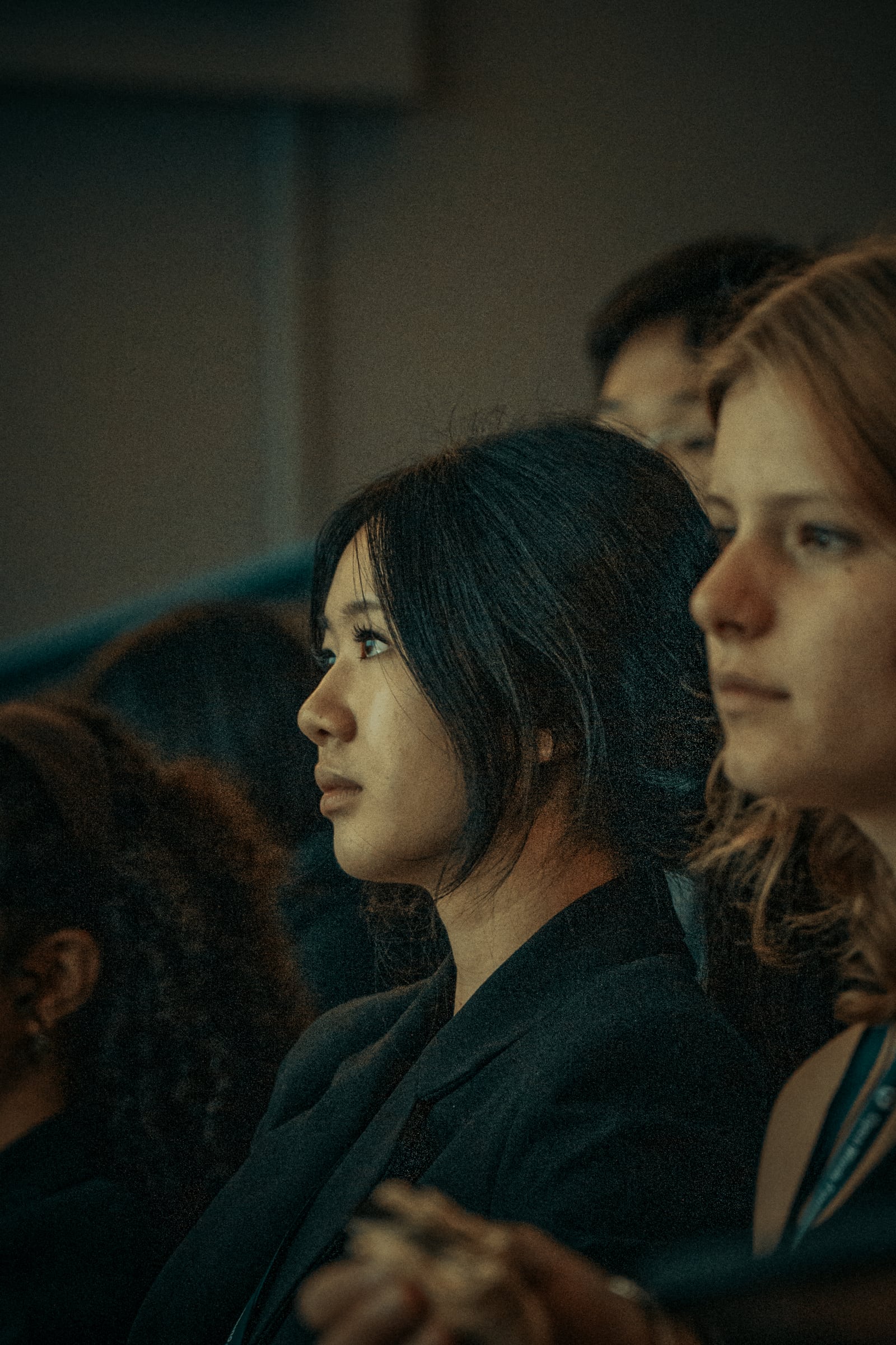 Two students listening side by side during a presentation