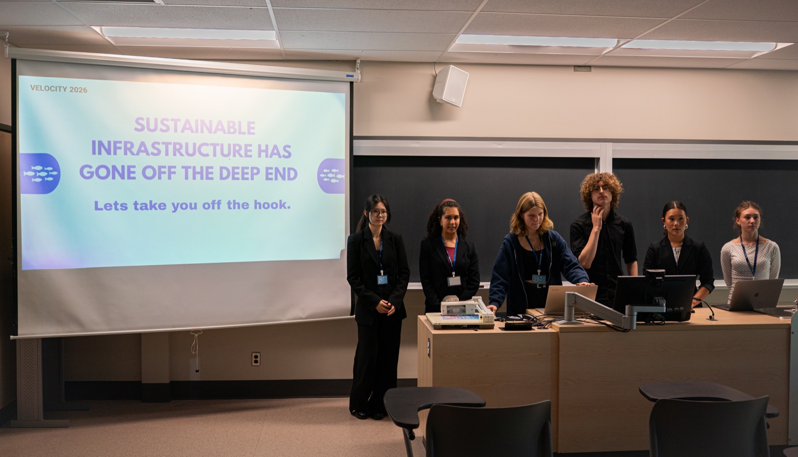 Teams lined up at the front of the classroom during the presentations